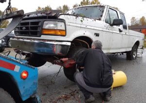 Joe filling tire with air compressor