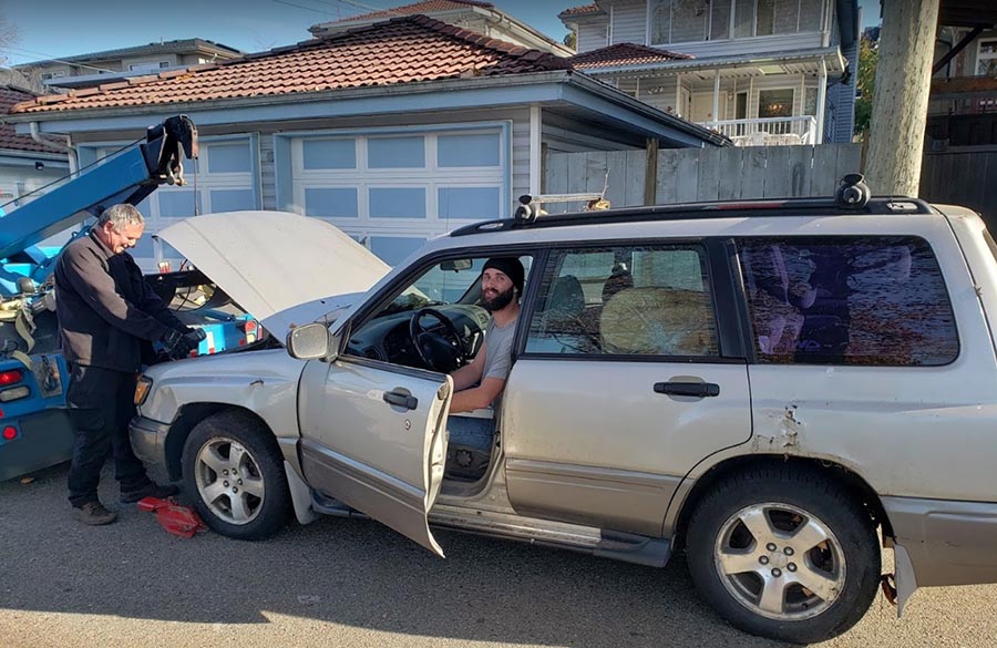 Joe towing a junk car